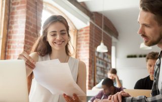 Businesswoman discussing documents at meeting with client