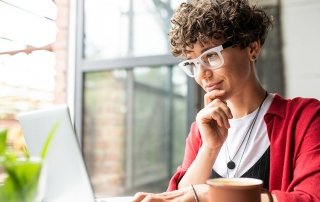 Busy young woman working on laptop